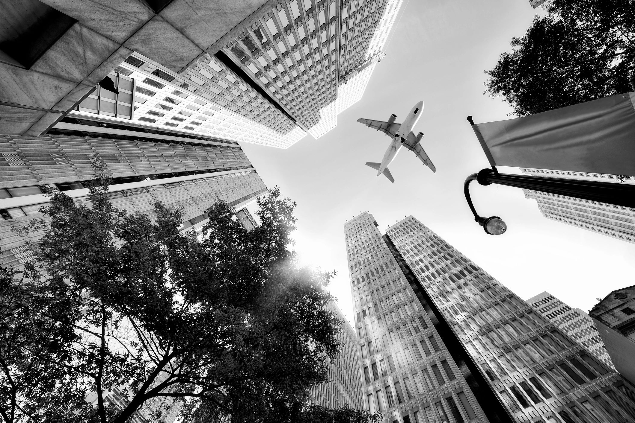 Aircraft in flight above urban towers