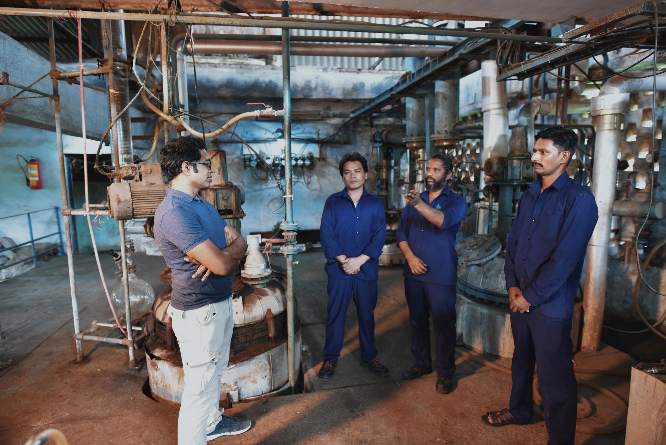 Team members discussing work in an industrial setting