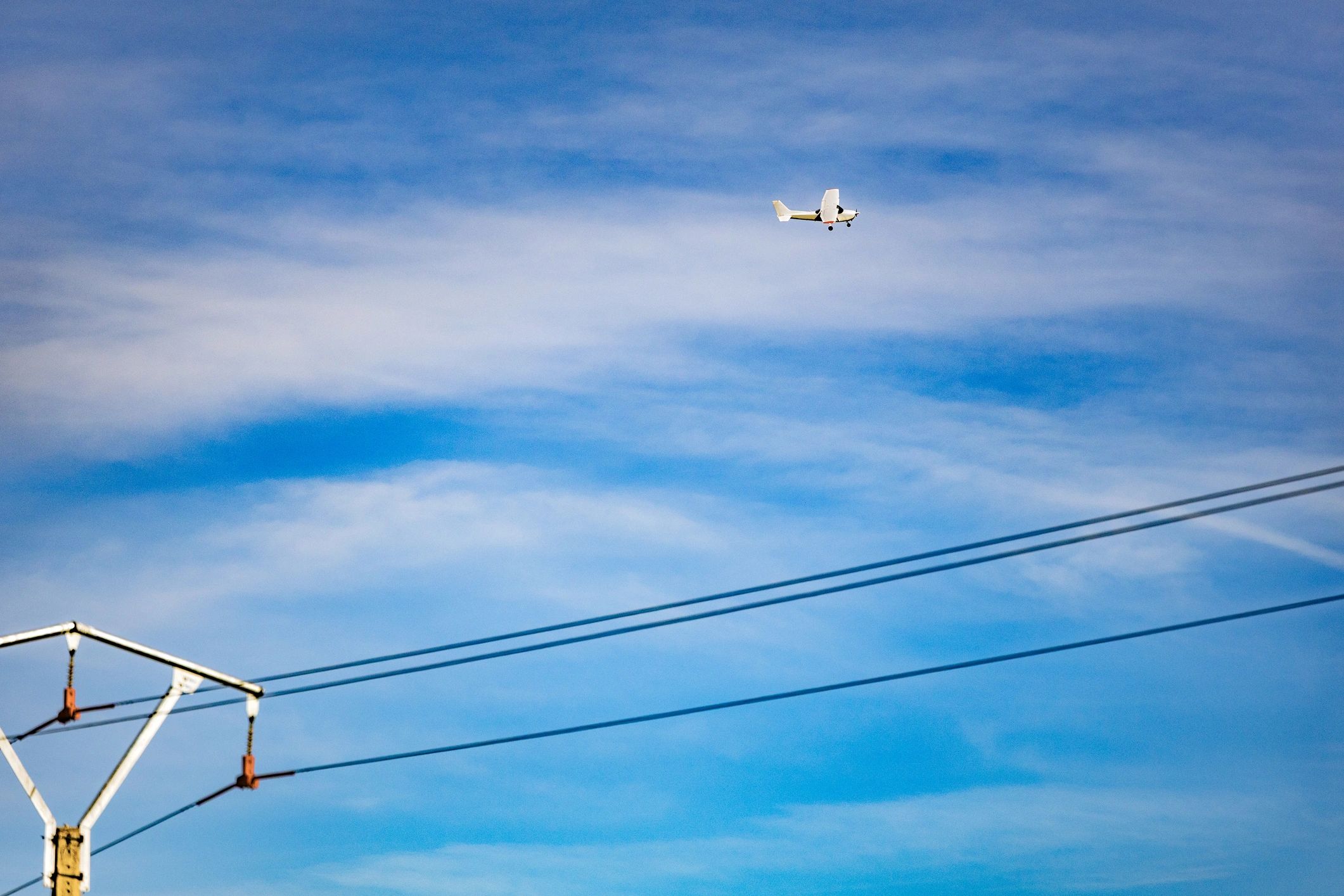 Electric aircraft in flight against a blue sky